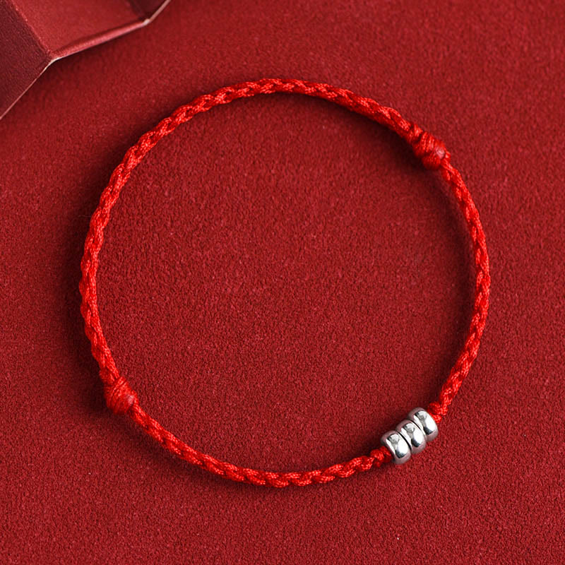 Red ankle bracelet with sterling silver beads and adjustable braided cord design