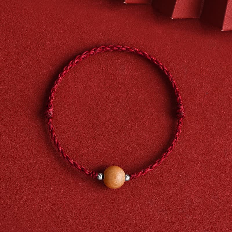 Red string protection bracelet with natural peach wood bead and silver accents