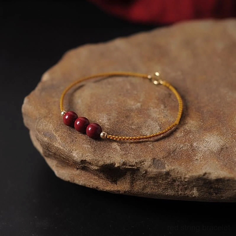 14K gold plated natural cinnabar braided bracelet yellow cord 3 beads view