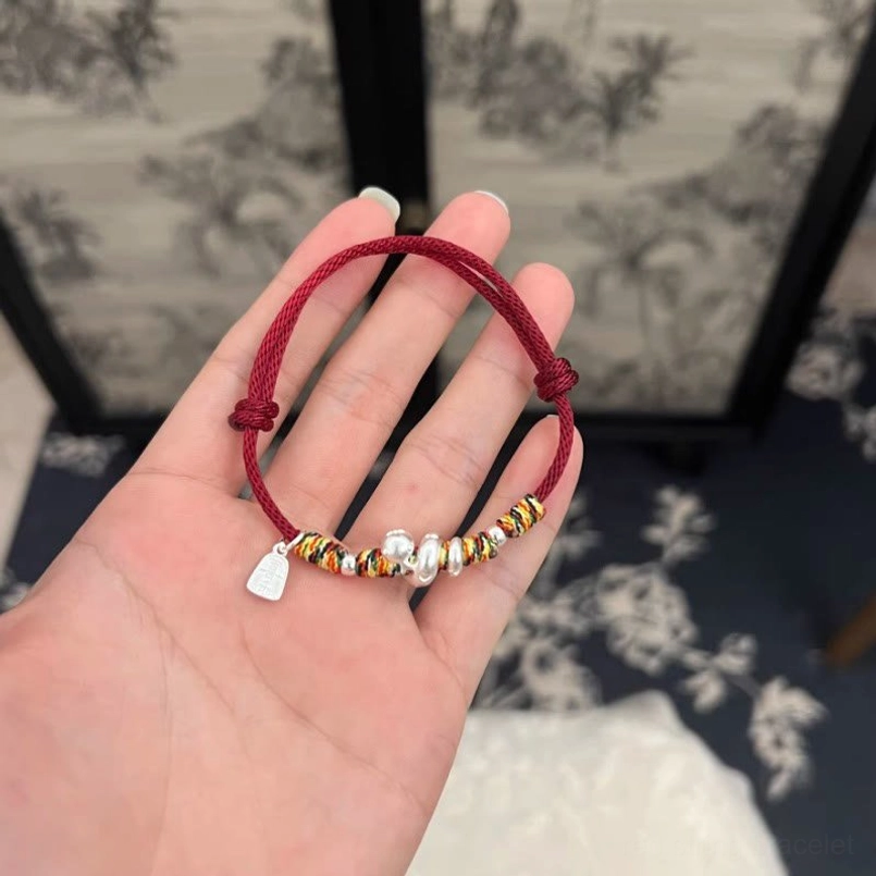 999 Sterling Silver Year of Snake Red String Bracelet placed on open palm