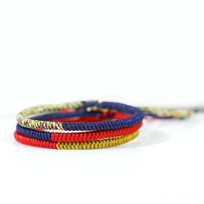 Stacked Tibetan protection braided red string bracelets top view