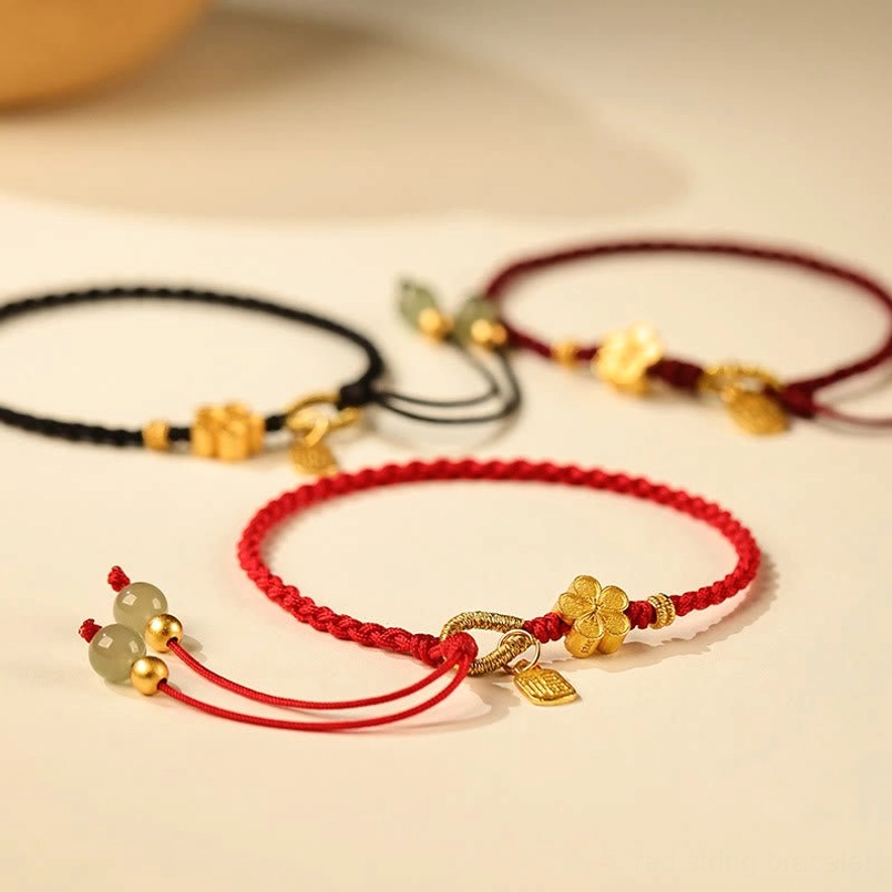 Three styles of red black dark red Hetian jade luck bracelets top down view