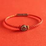 925 sterling silver fu character red string bracelet flat lay on red background