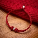 925 sterling silver bead red string braided bracelet main view on wooden desk
