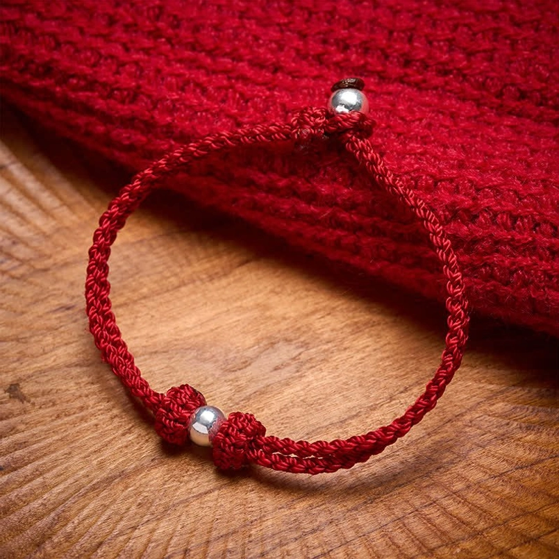925 sterling silver bead red string braided bracelet main view on wooden desk