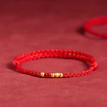 925 sterling silver plated gold beads red string bracelet top front view on red velvet