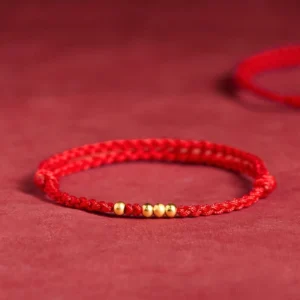 925 sterling silver plated gold beads red string bracelet top front view on red velvet
