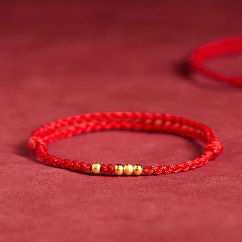 925 sterling silver plated gold beads red string bracelet top front view on red velvet