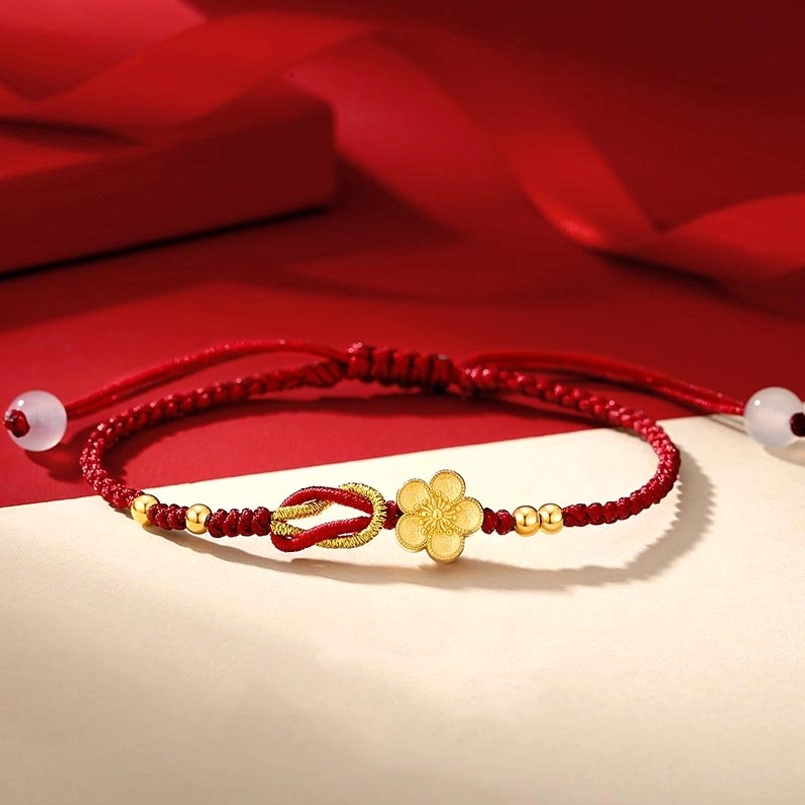925 sterling silver sakura red string bracelet flat lay on red gift box backdrop