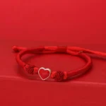 999 Sterling Silver 3D Heart Red String Bracelet front view on solid red background