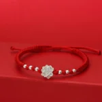 999 sterling silver lotus red string luck bracelet flat front view on red background