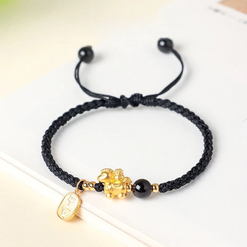 999 sterling silver year of the horse black string bracelet flat lay on white table
