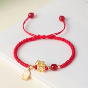 999 sterling silver year of the horse red string bracelet flat lay on white table