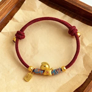 999 sterling silver year of the horse fu charm red string bracelet on wooden tray