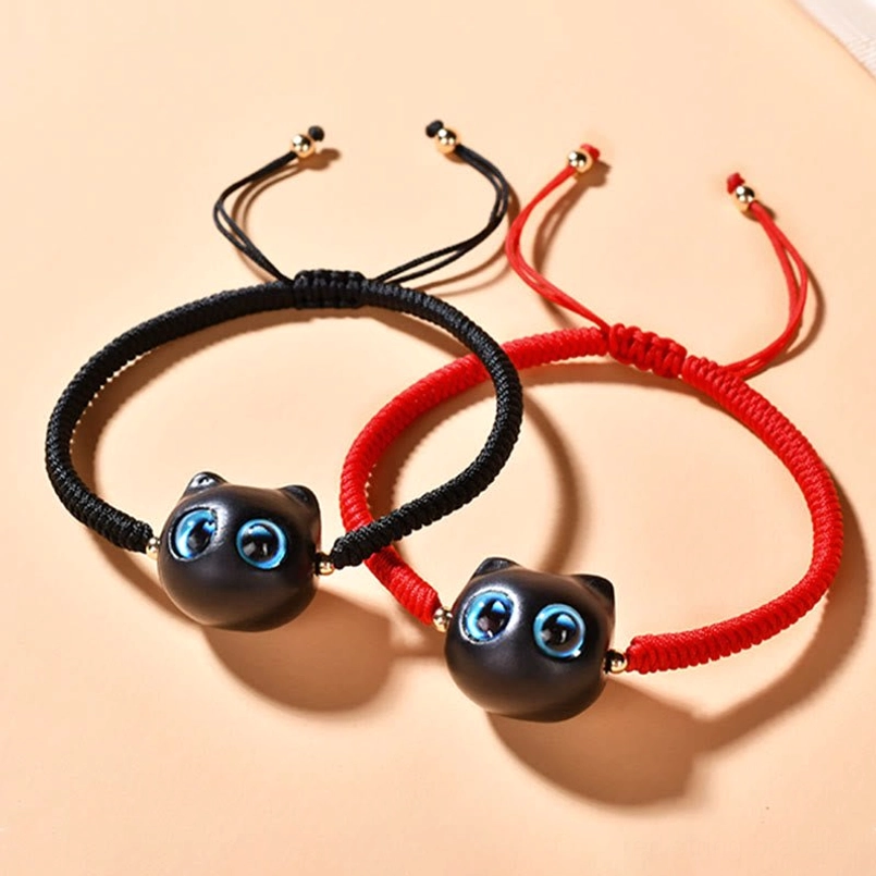 Pair of ebony wood cat bracelets with matching black cat charms and adjustable pull knots