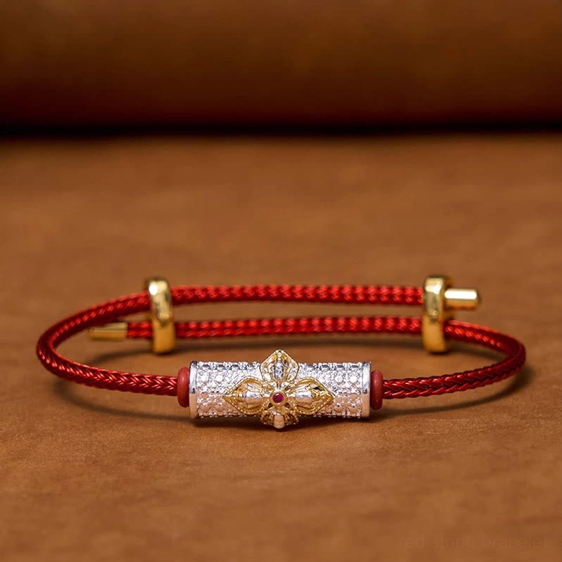 Adjustable copper luck bracelet with red string and decorative flower charm