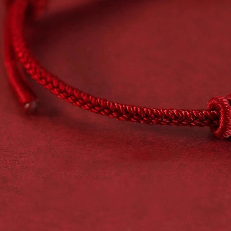 Side view of adjustable closure design on eight stranded red string bracelet