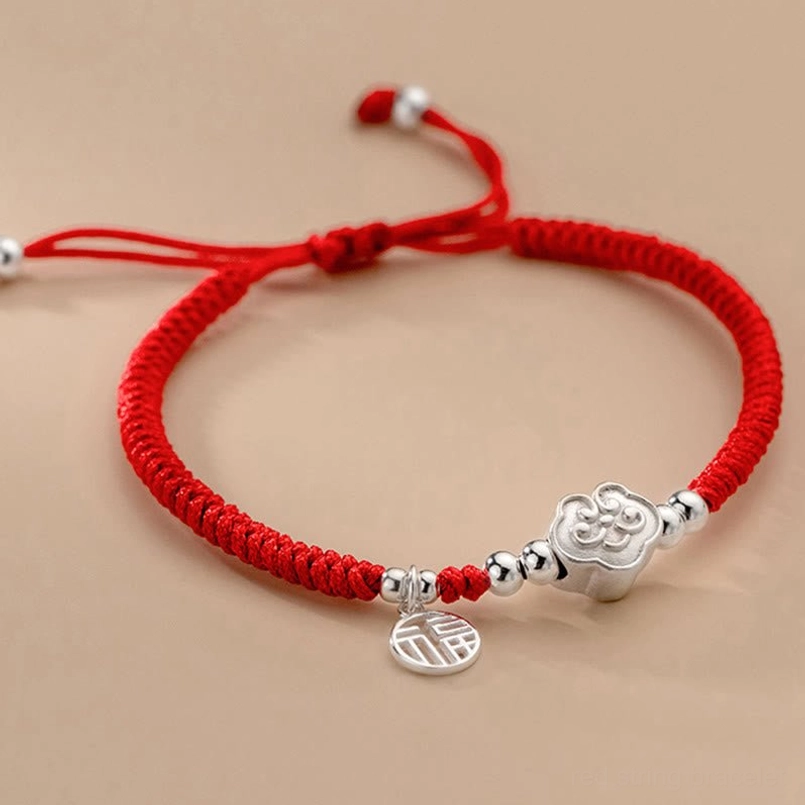 Side top view of adjustable Fu charm red string bracelet with sterling silver beads