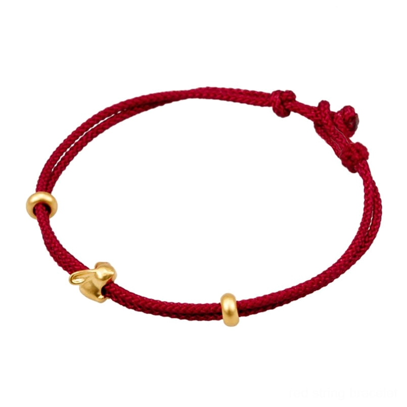 adjustable gold rabbit red string bracelet flat lay on white background