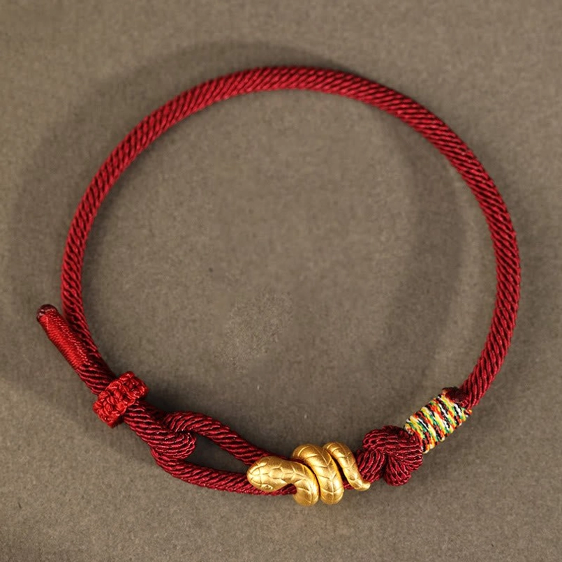 single burgundy gold snake braided bracelet top down flat lay adjustable knot