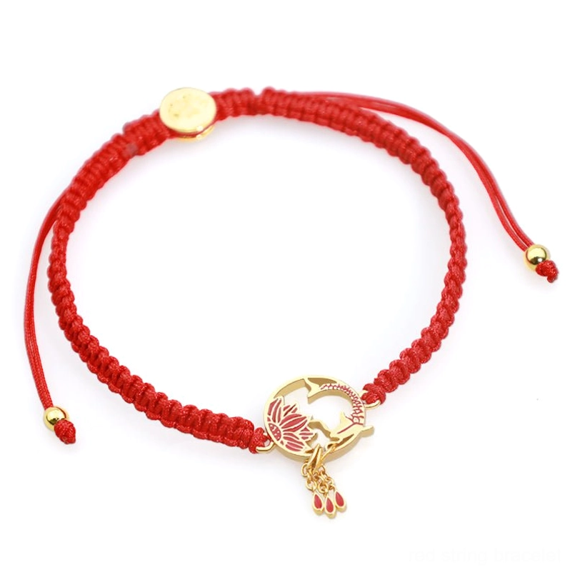 Adjustable red cord bracelet with pull knot sliders and gold lotus charm - front overhead