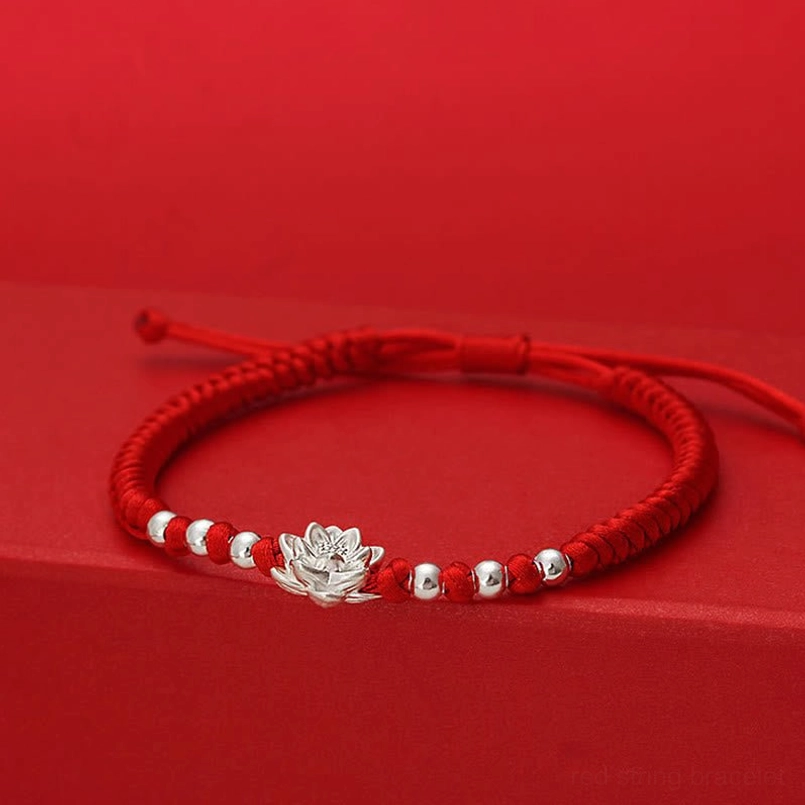 Adjustable red string silver lotus luck bracelet elevated front view with sliding knot