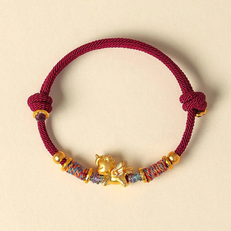 Adjustable braided red string bracelet with gold horse charm