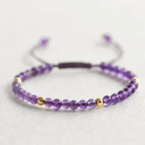 handmade 4mm natural amethyst braided string bracelet with gold plated copper beads close-up view
