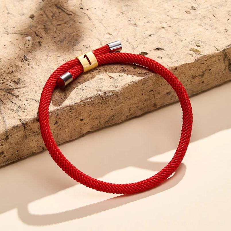 Angel number 7 red string bracelet wooden ledge with soft shadow lighting