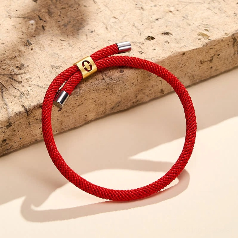Angel number 9 red string bracelet profile with wooden backdrop