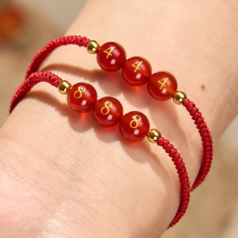 Angel Number Bracelets worn on wrist showing multiple styles with engraved numbers and gold spacers