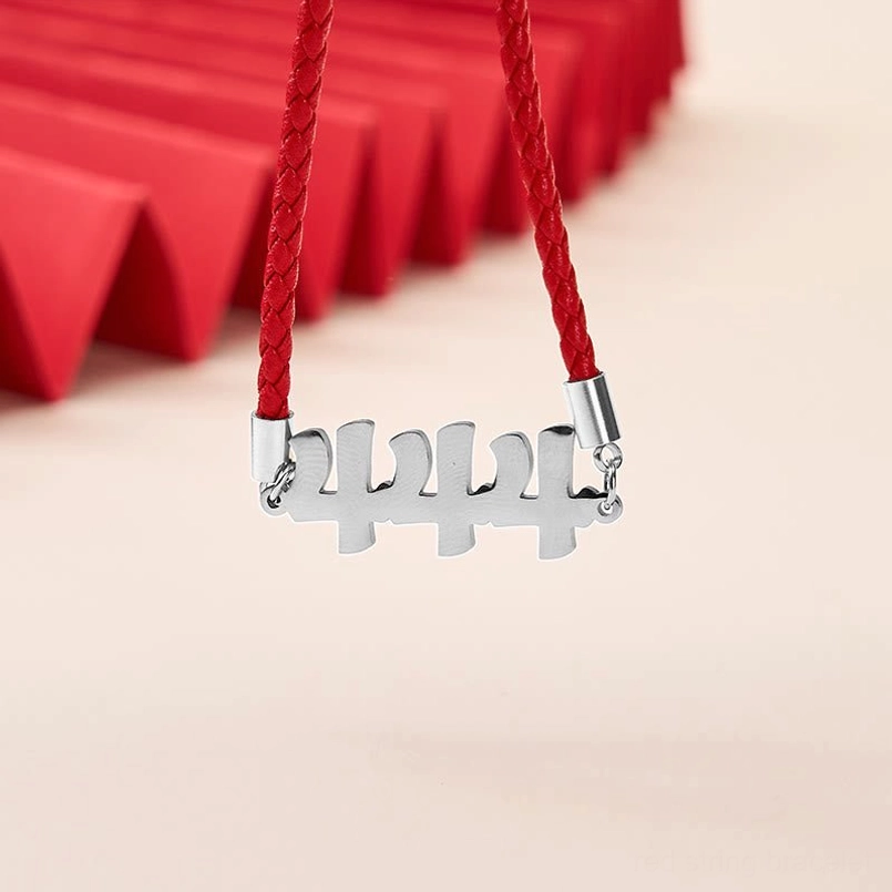 Angel Numbers 444 silver pendant red braided string bracelet close-up