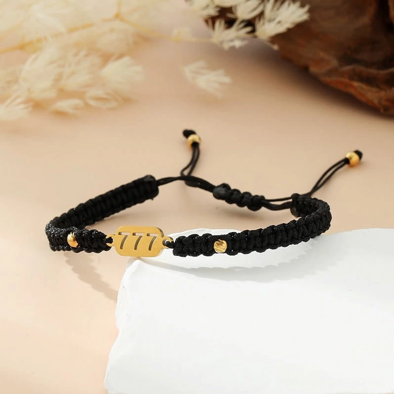 Angel numbers red string bracelet with gold nameplate close up detail