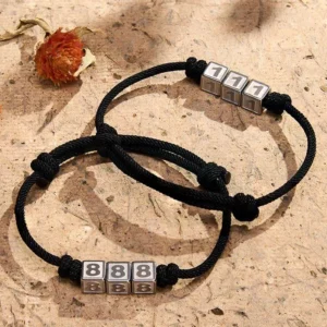 Angel numbers adjustable black string bracelets collection flat lay with dried flowers