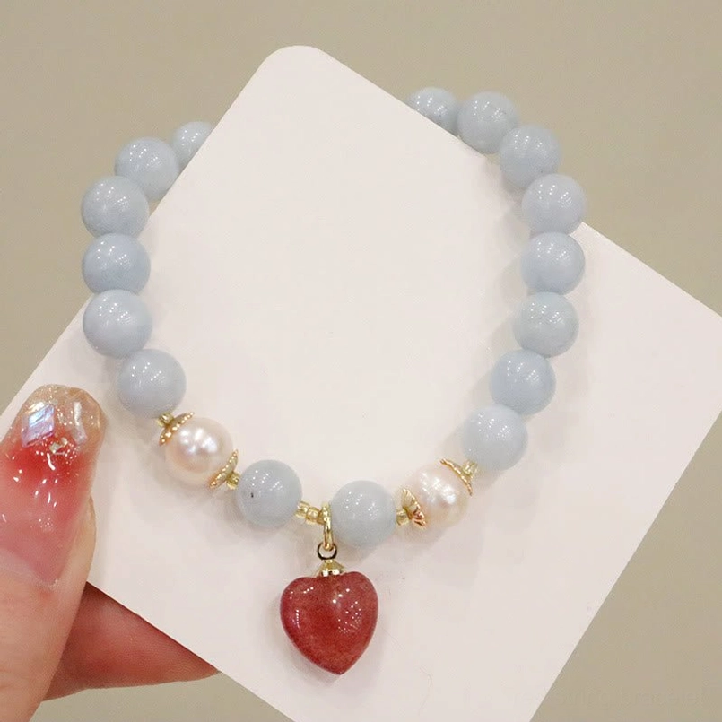 Aquamarine chalcedony charm bracelet flat lay on white card, showcasing all beads and pendant details