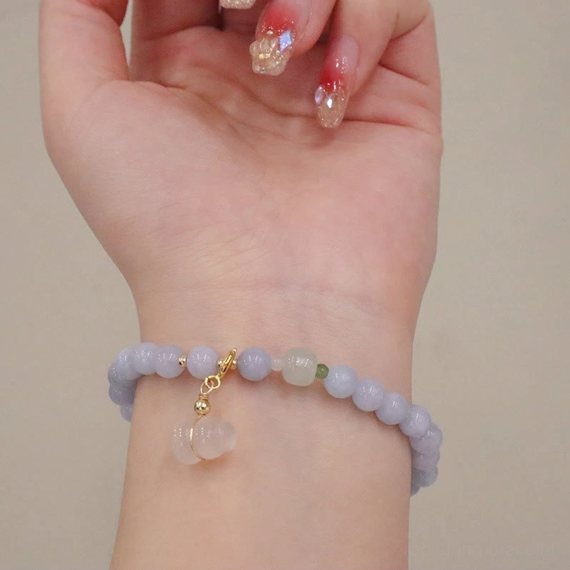 Aquamarine beaded bracelet with dangle charm, gold loops and clear square stone pendant detail