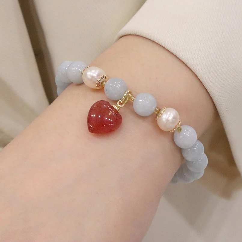 Aquamarine love heart charm bracelet with light blue beads, gold clasp and heart stone pendant