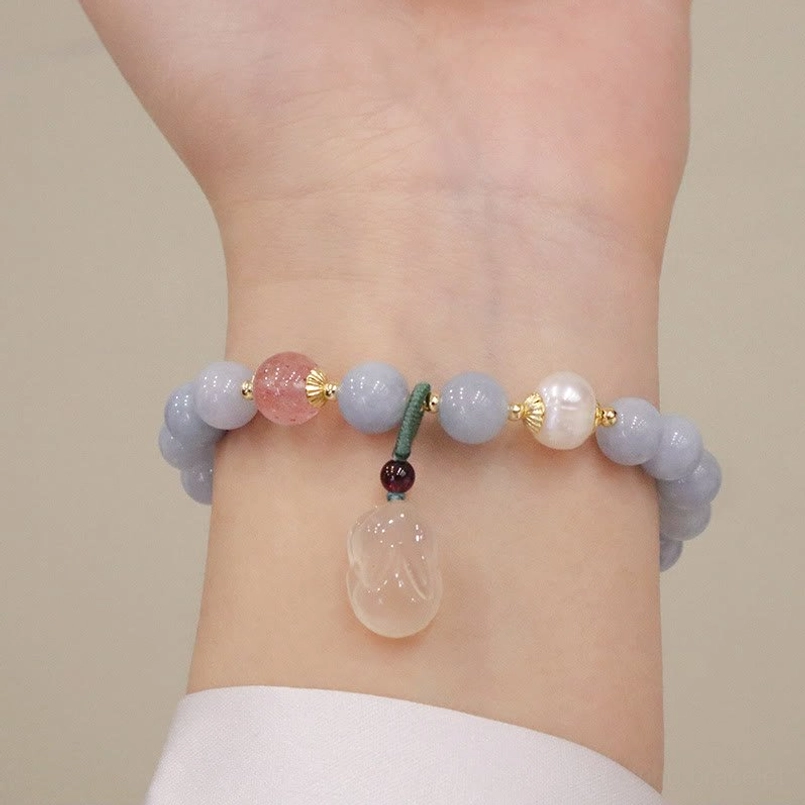 Aquamarine rabbit charm bracelet with pink strawberry quartz and clear jade rabbit pendant on wrist