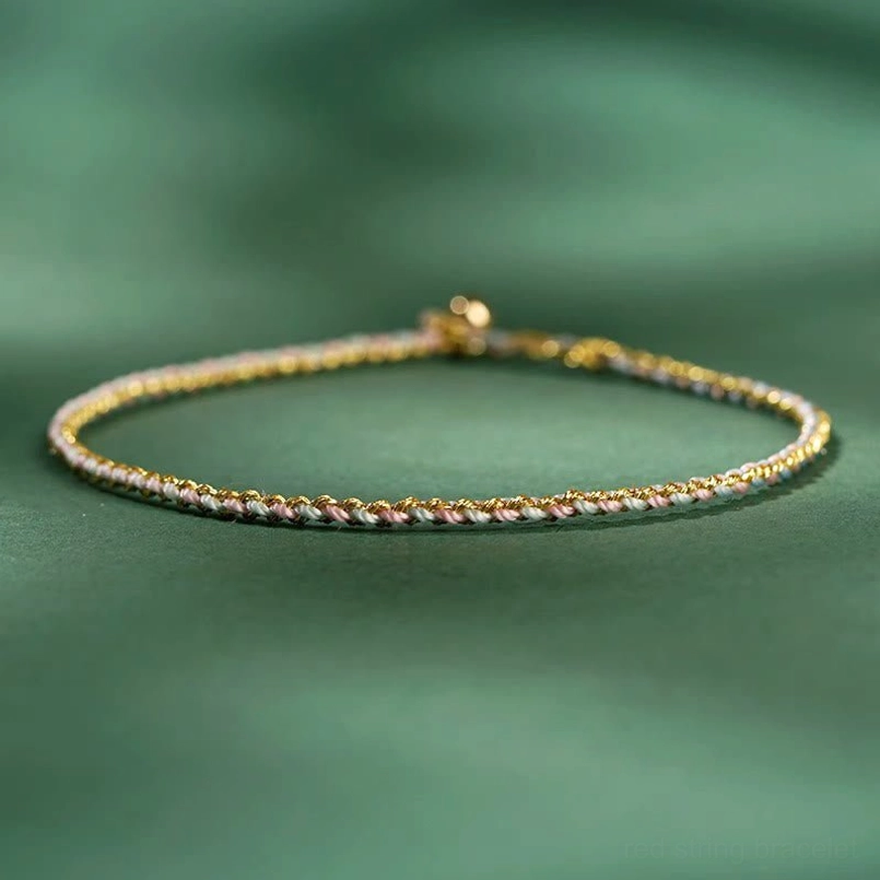 Thin colorful braided lucky coin bracelet with gold coin pendant showing artisan craftsmanship