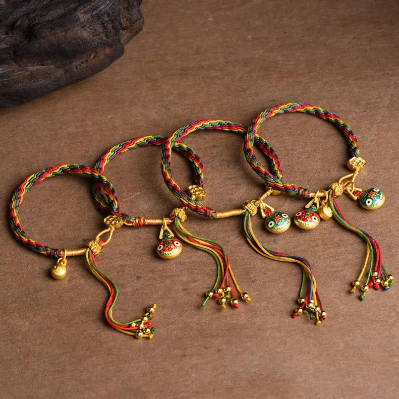 Auspicious Pixiu charm bracelet placed on dark wooden surface