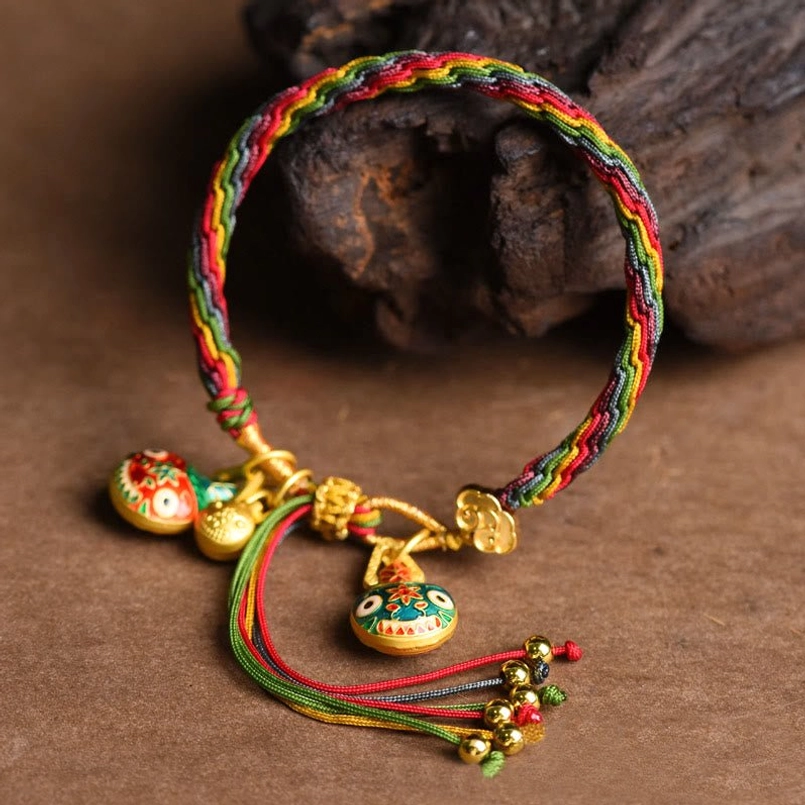 Tibetan lucky braided string bracelet top view with gold tassel details