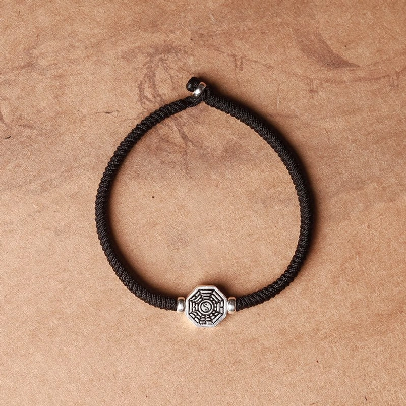 Red woven string bracelet with yin yang bagua protection pendant