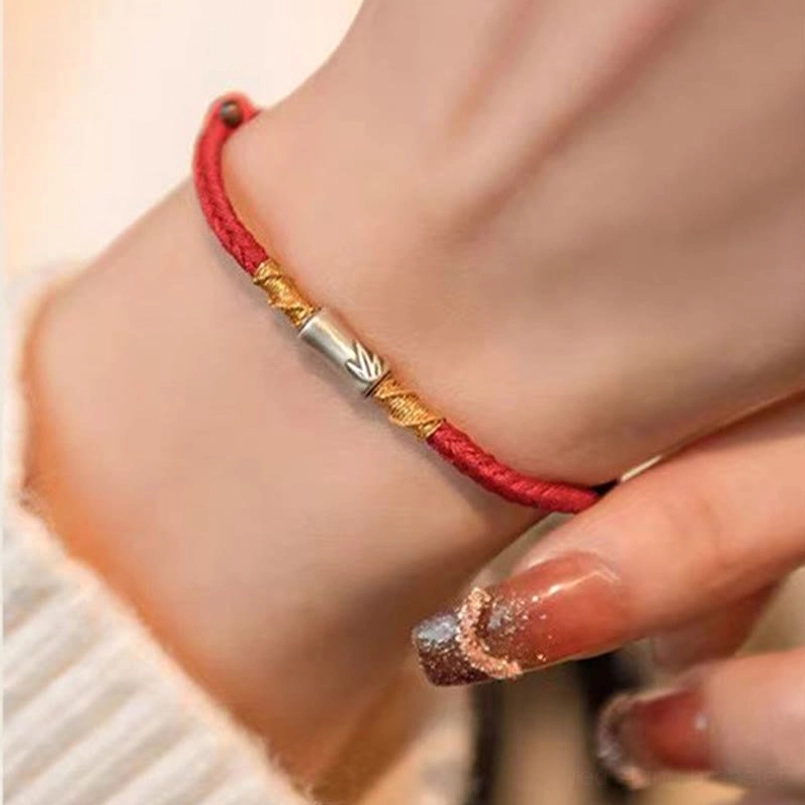 Bamboo design red bracelet side wrist closeup with manicured nails