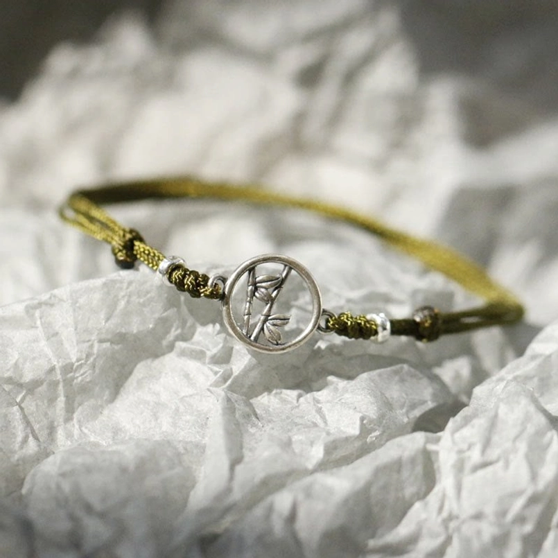 925 sterling silver bamboo bracelet with decorative metal spacer beads on white parchment