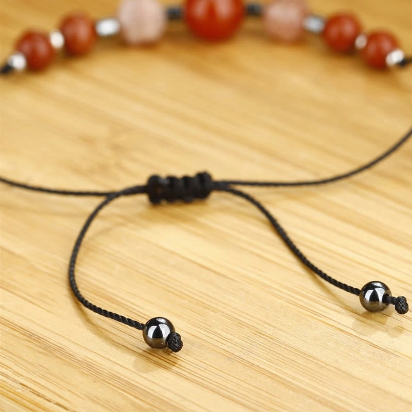 Macro close-up of carnelian sunstone hematite beads and black waxed cord texture