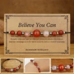 Believe You Can bracelet with carnelian red jasper hematite sunstone beads on display card - flat lay product shot