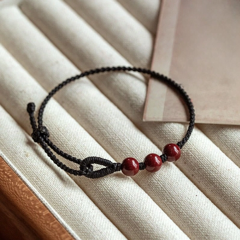 Black braided cinnabar bead protection bracelet top view