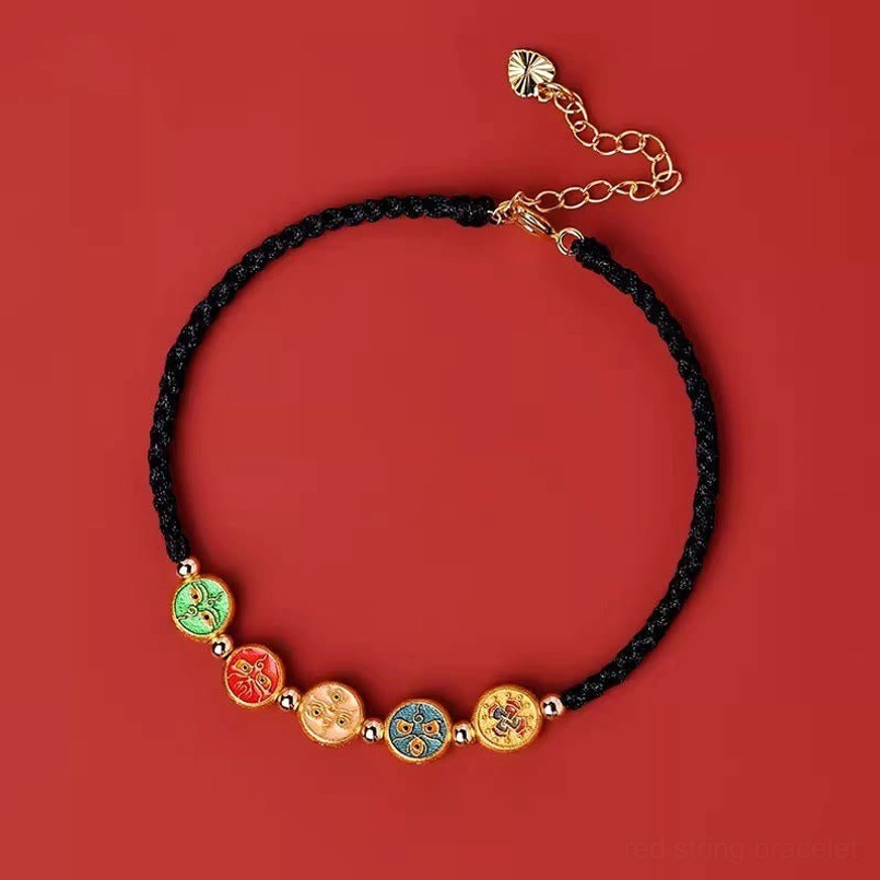 black string five ways god of wealth bracelet flat lay on red background