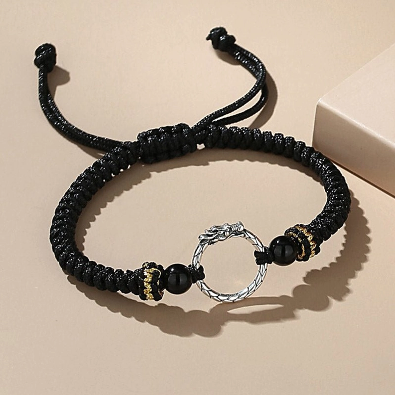 Black dragon phoenix lucky bracelet with silver charm - top view flat lay