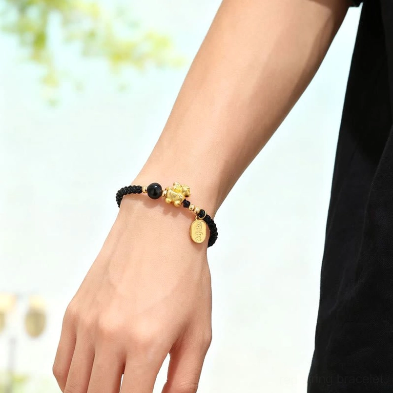 Year of the horse black string bracelet worn on female wrist lifestyle shot